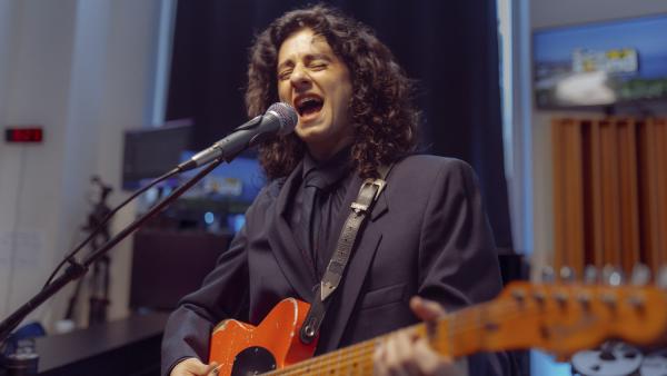 MARILINA BERTOLDI SINGING INTO MICROPHONE